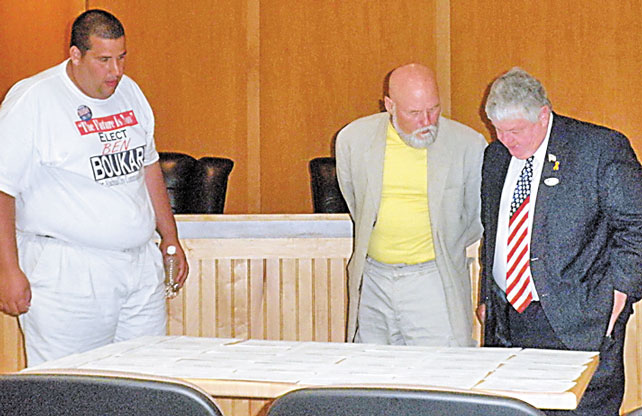 L-R: Alachua City Commission Candidates Ben Boukari, Duane Helle and Robert Wilford review absentee ballots following Tuesday's election